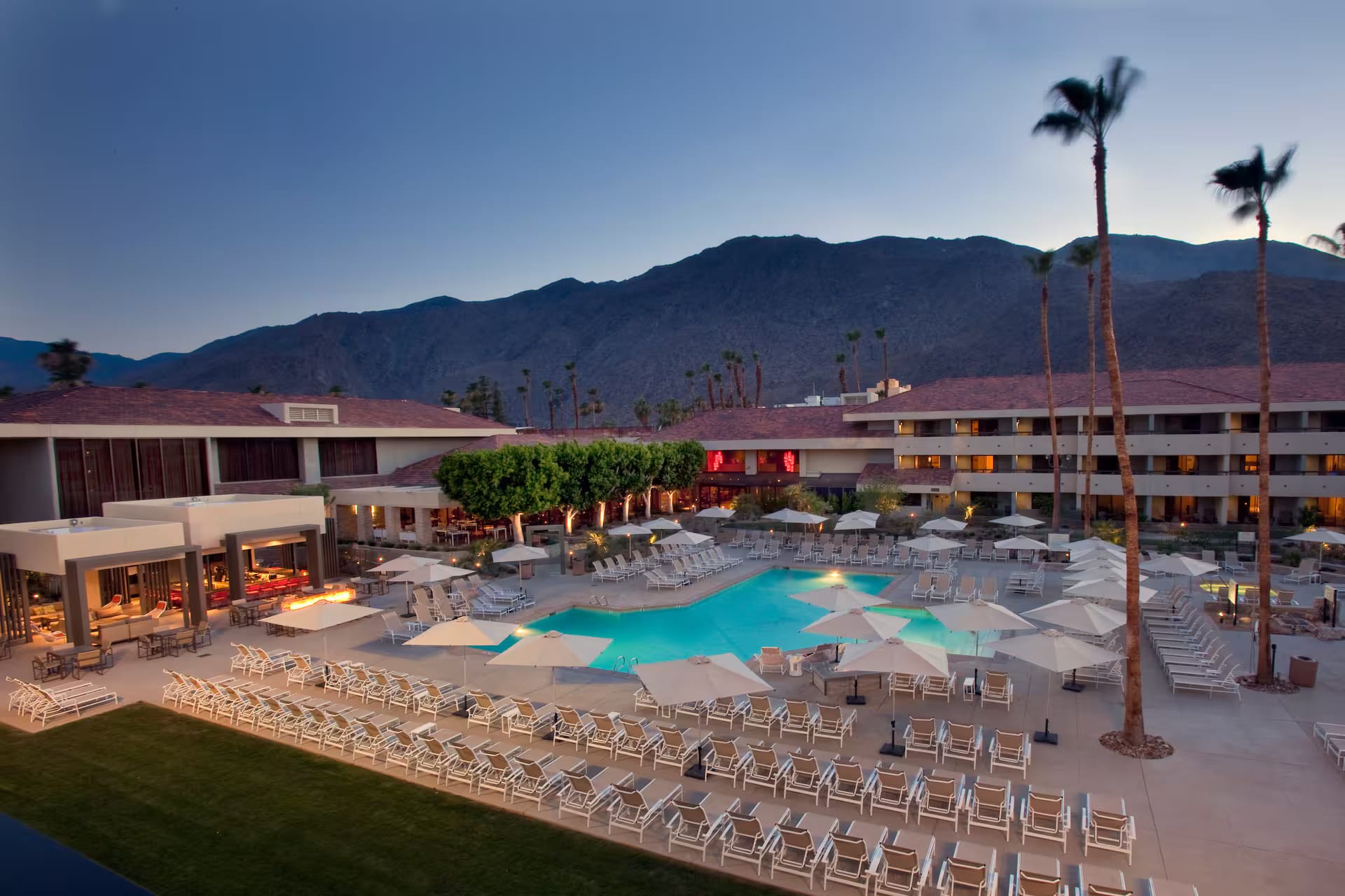 Pool courtyard at dusk at Hilton Palm Springs